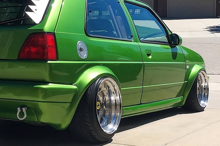 Green Volkswagen MK2 GTI Golf with wide fender flares and deep dish wheels
