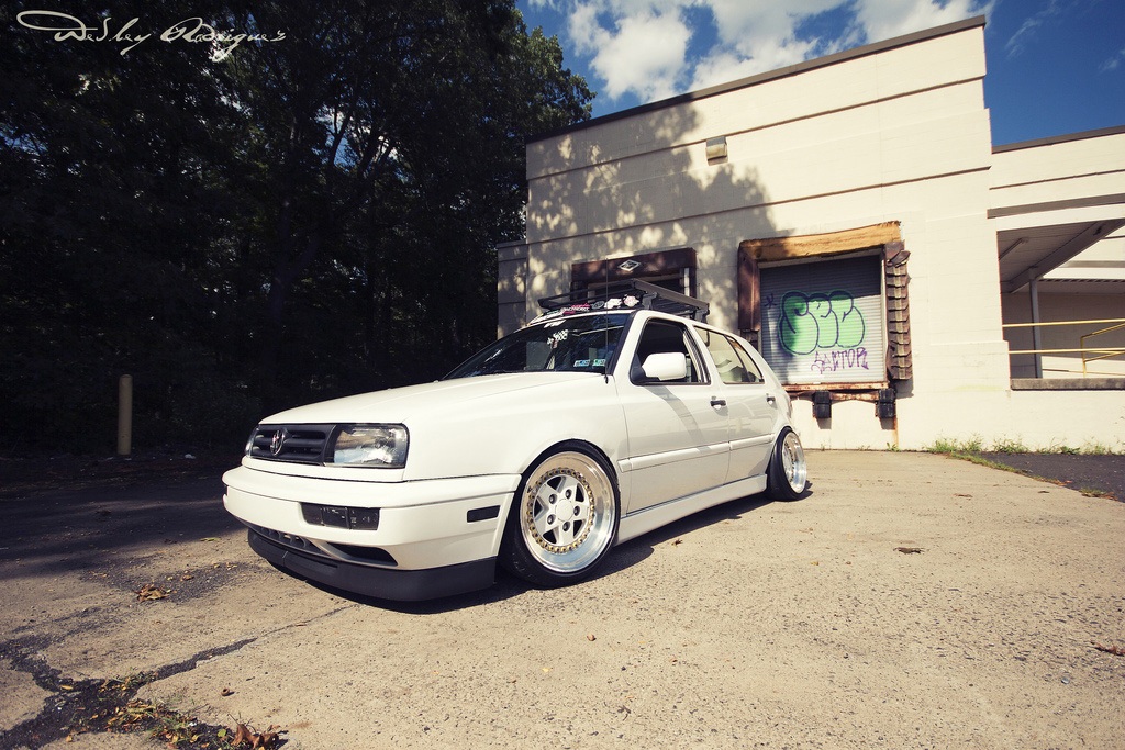 White Volkswagen MK3 Golf with OptikWerks smoothed ABT style side skirts installed