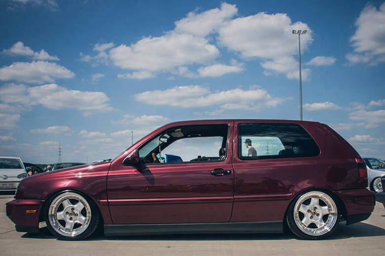 Burgundy two-door Volkswagen MK3 Golf with textured side skirts