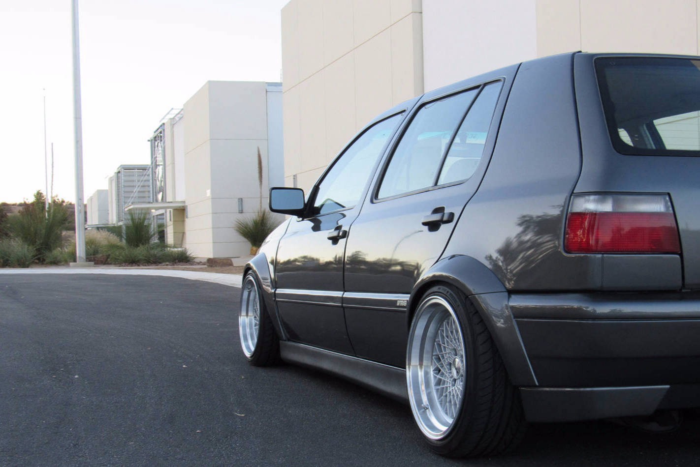 Gray Volkswagen MK3 Golf rear view with textured side skirts