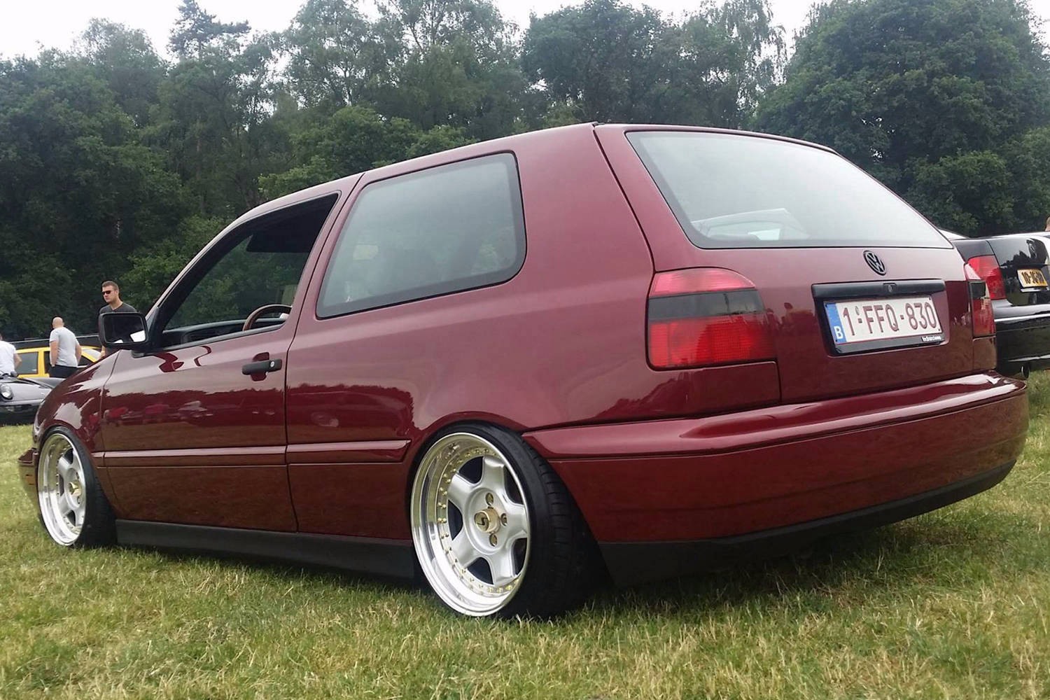 Red two-door Volkswagen MK3 Golf with textured side skirts