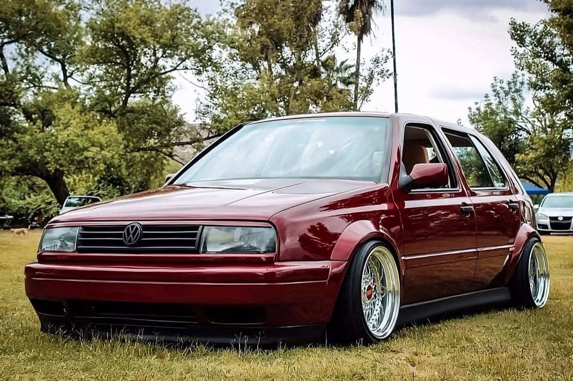Red Volkswagen MK3 Golf with ABT textured side skirts