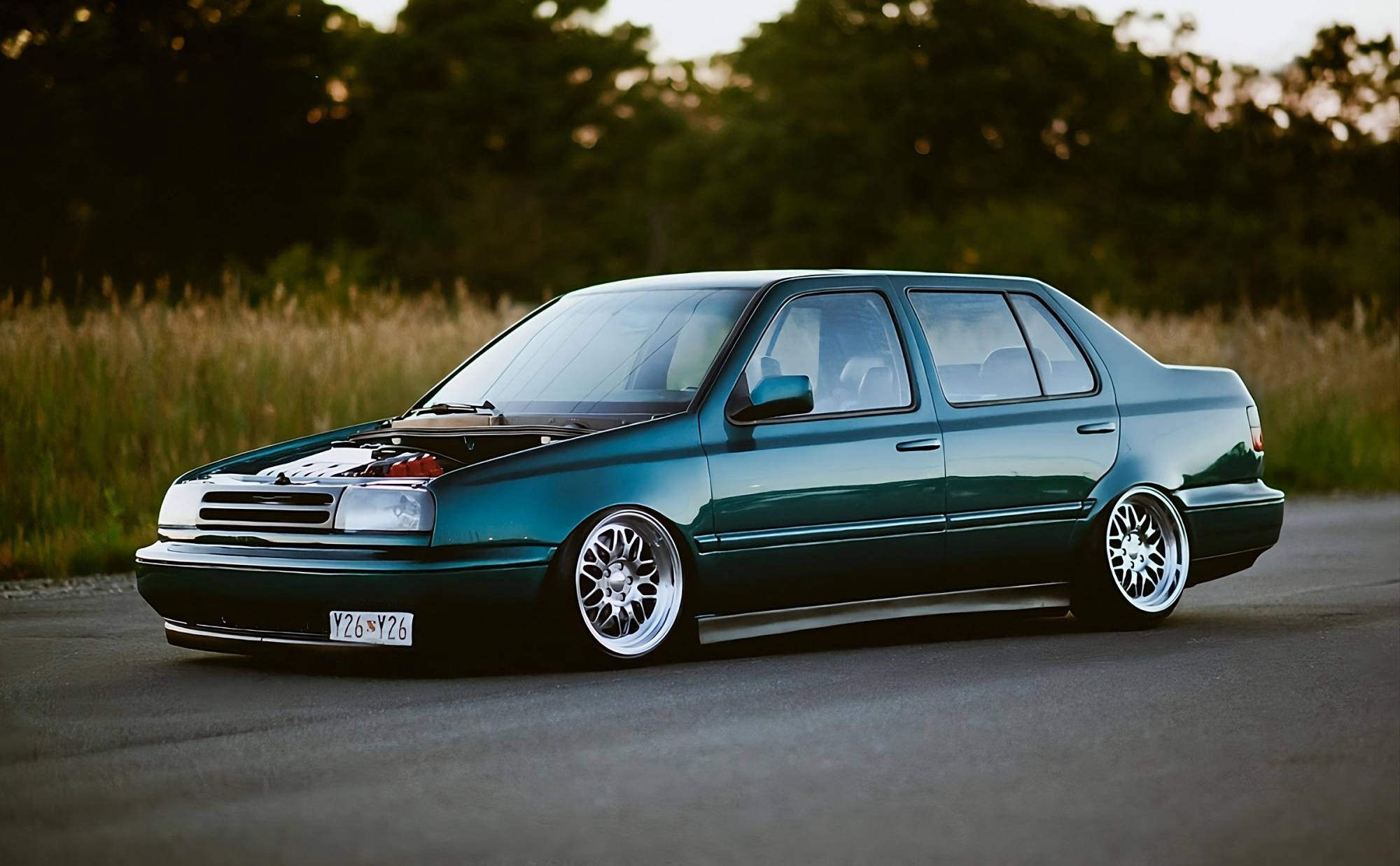 Green Volkswagen MK3 Jetta side view with textured side skirts