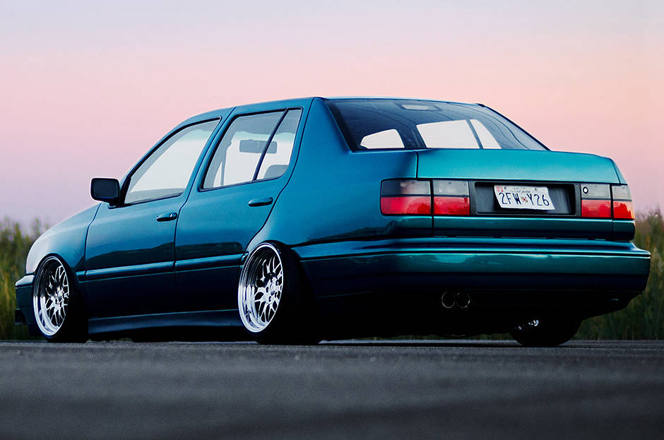 Teal Volkswagen MK3 Jetta rear view with textured side skirts