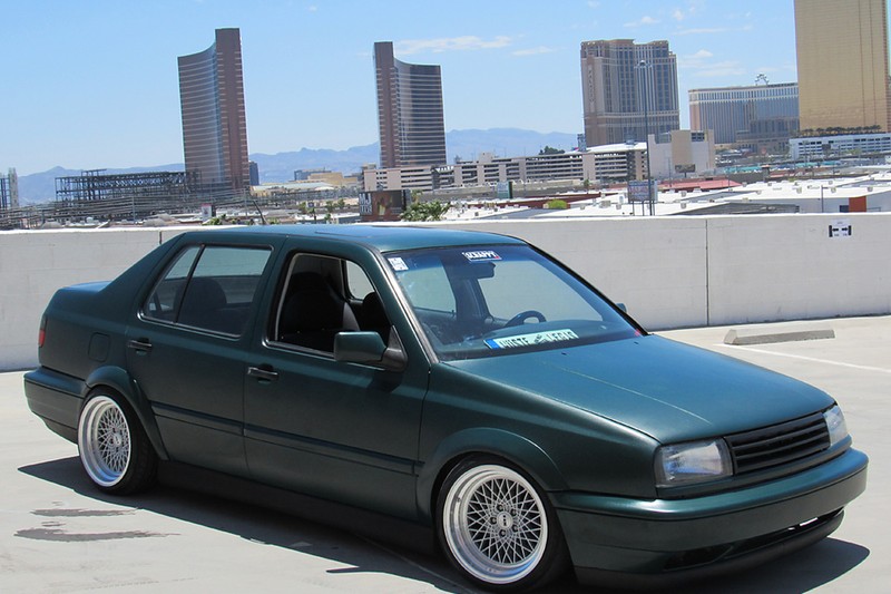 Green Volkswagen MK3 Jetta with widened Euro flares, front three-quarter view in Las Vegas
