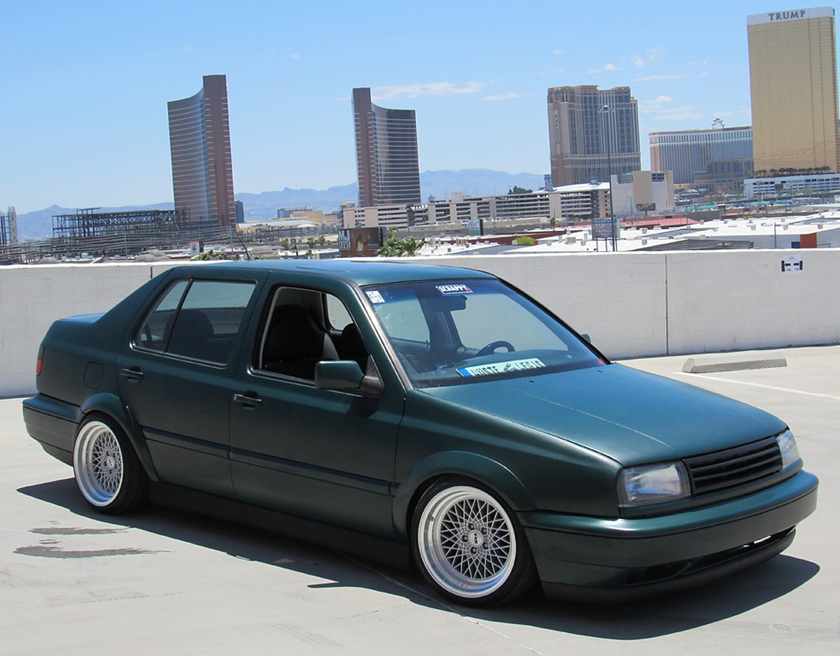 Green Volkswagen MK3 Jetta with widened Euro flares, front three-quarter view in Las Vegas
