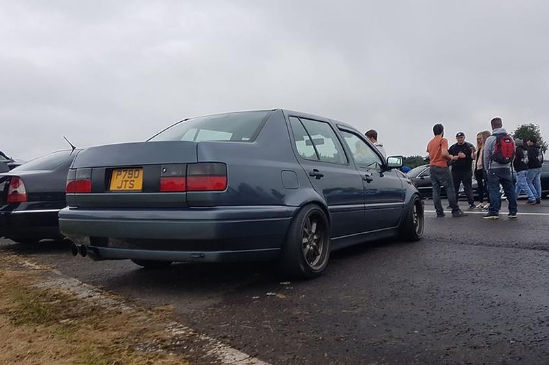 Gray Volkswagen MK3 Jetta with widened Euro flares at a car meet