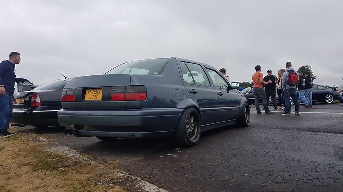 Gray Volkswagen MK3 Jetta with widened Euro flares at a car meet