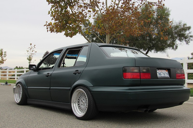 Green Volkswagen MK3 Jetta showing widened rear Euro flare fitment