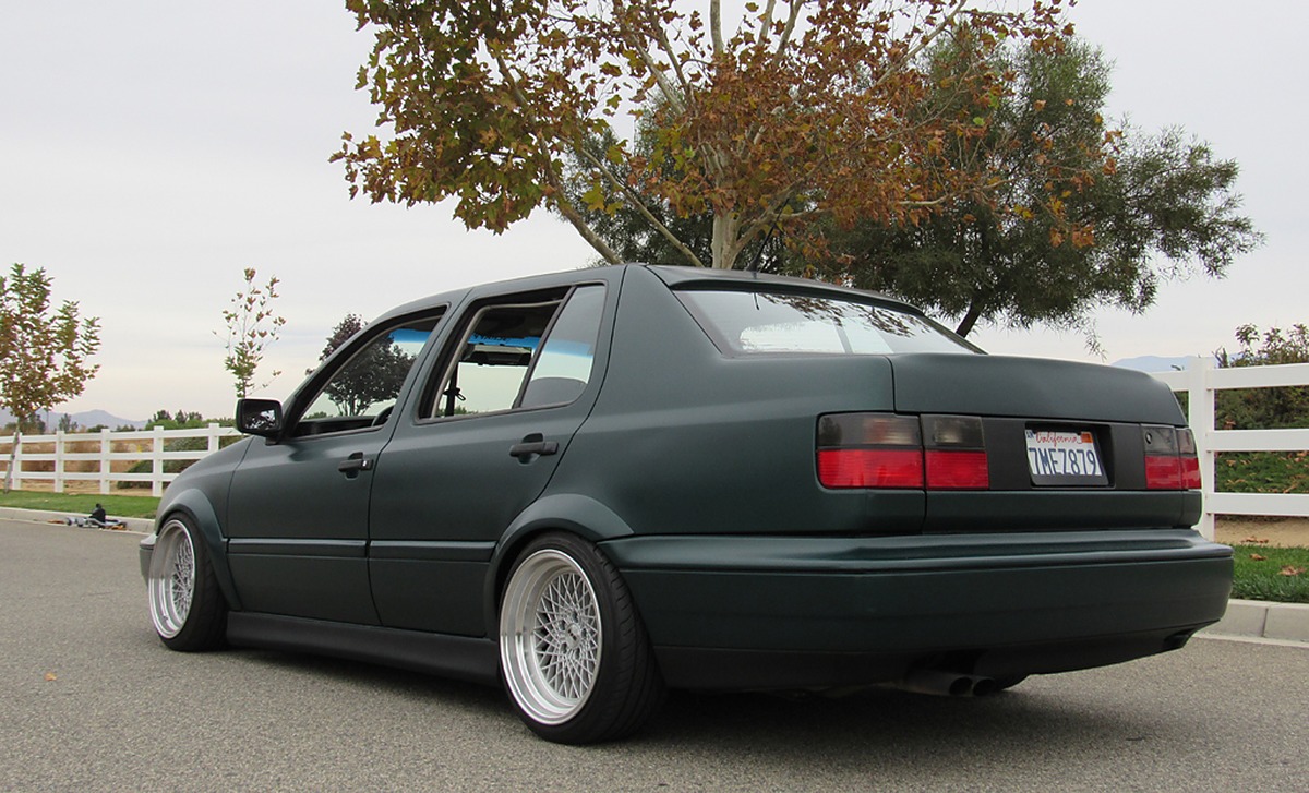 Green Volkswagen MK3 Jetta showing widened rear Euro flare fitment