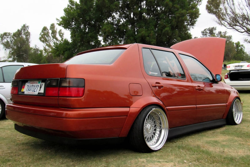 Rear quarter view of Volkswagen Jetta MK3 Vento with wide body fender flares, lowered stance and deep dish wheels by Optikwerks