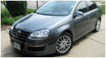 Gray Volkswagen MK5 Jetta front view with Votex style side skirts installed