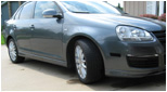 Gray Volkswagen MK5 Jetta side view with Votex style side skirts installed