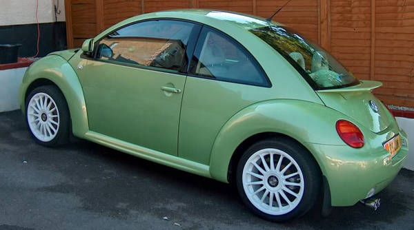 Green VW New Beetle showing the full-length rocker and Votex style side skirt profile