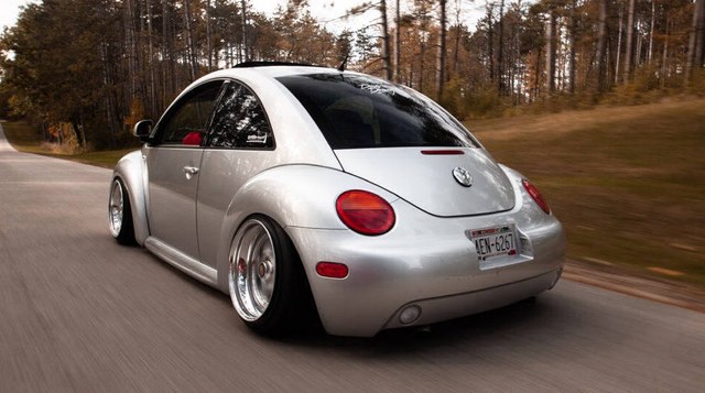 Silver VW New Beetle with Votex style side skirts, rear three-quarter view