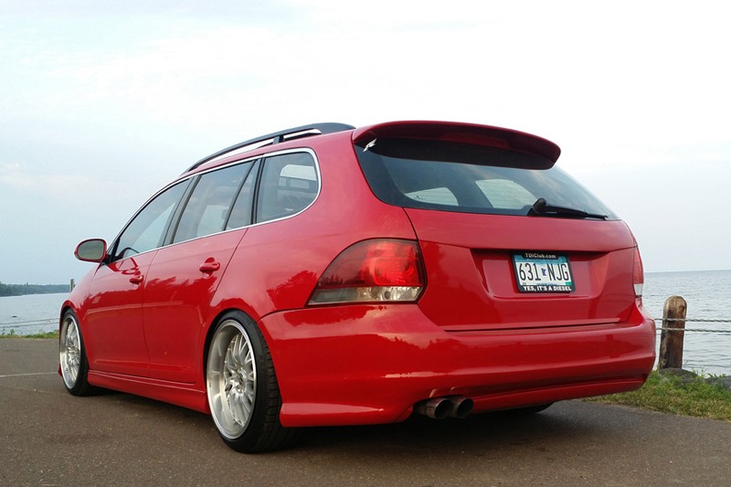 Red 2009–2014 VW Jetta SportWagen rear view with full-length Votex style side skirts
