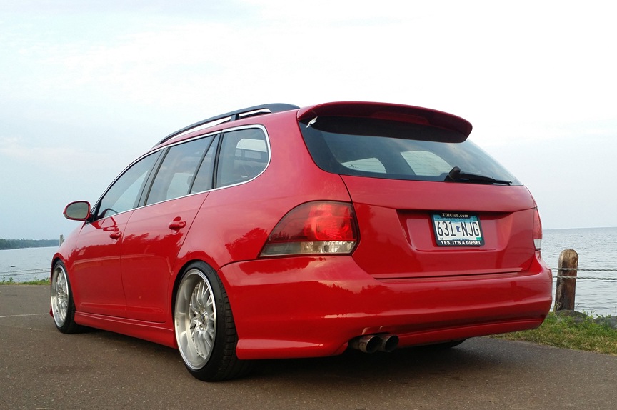 Red 2009–2014 VW Jetta SportWagen rear view with full-length Votex style side skirts